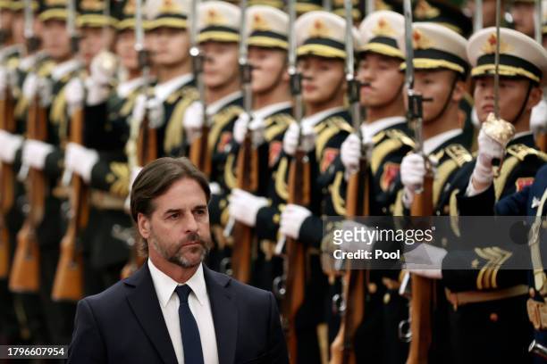 Uruguay President Luis Lacalle Pou reviews the the honour guard during a welcome ceremony at The Great Hall of the People on November 22, 2023 in...