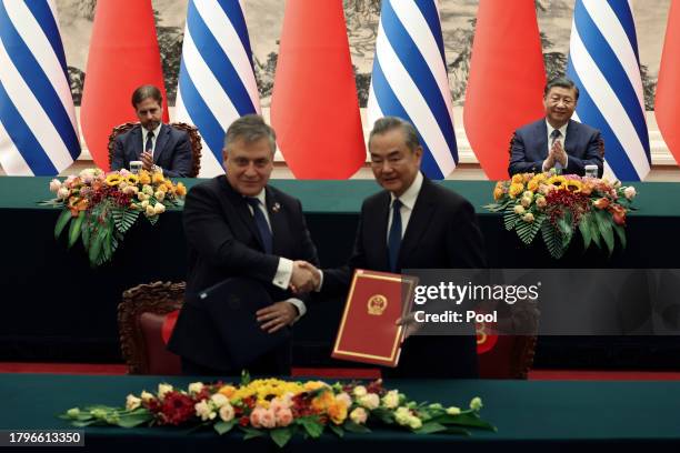 Chinese President Xi Jinping and Uruguay President Luis Lacalle Pou attend a signing ceremony with Chinese Foreign Minister Wang Yi and Uruguay...