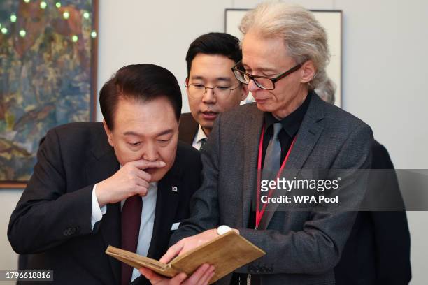 Head of Library at The Royal Society, Keith Moore , shows an artifact to South Korea's President Yoon Suk Yeol at the Royal Society on November 22,...