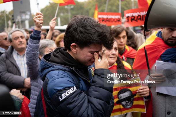 Demonstrator cries during a protest against the investiture of Pedro Sanchez on the day the second session of the plenary session in which he will be...