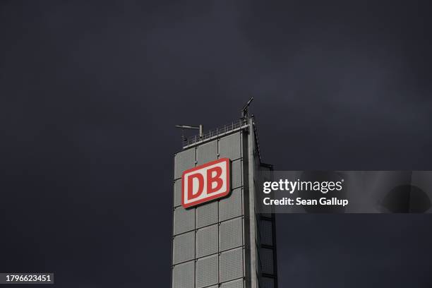 The logo of German state rail carrier Deutsche Bahn stands under dark clouds at Hauptbahnhof mail railway station during a nationwide railway strike...