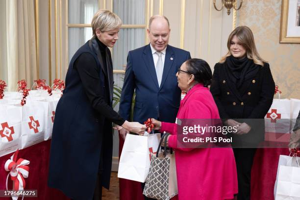 Princess Charlene of Monaco Prince Albert II of Monaco and Camille Gottlieb attend the Red Cross Christmas Gifts Distribution at Monaco Palace on...
