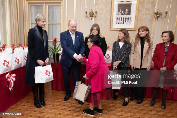 Princess Charlene of Monaco Prince Albert II of Monaco and Camille Gottlieb attend the Red Cross Christmas Gifts Distribution at Monaco Palace on...