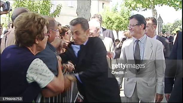 Grab taken from France Televisions shows a man grabbing French President Nicolas Sarkozy by the jacket as he was greeting people gathered behind a...