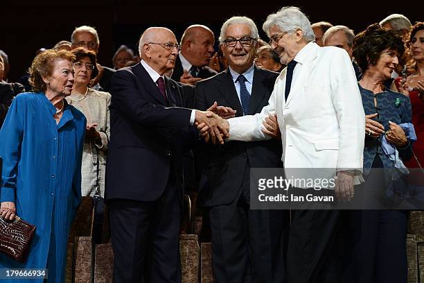 Film Director Ettore Scola is greeted as his wife looks on by President of La Biennale Paolo Baratta Italian Presiden Giorgio Napolitano and his wife...