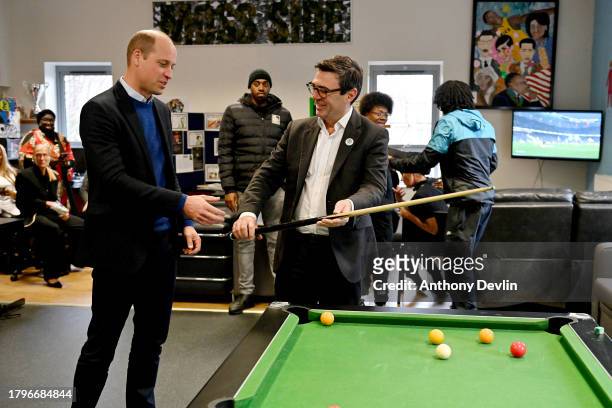 Prince William, Prince of Wales and Mayor of Greater Manchester, Andy Burnham play pool at the Hideaway Youth Project, lead partner of the Manchester...