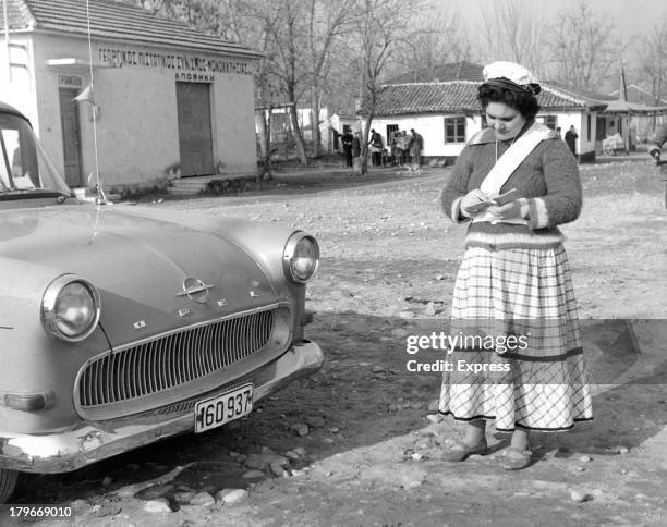 Women takes down the cars license plate number in Monoklissia,Greece, 1/11/1964.