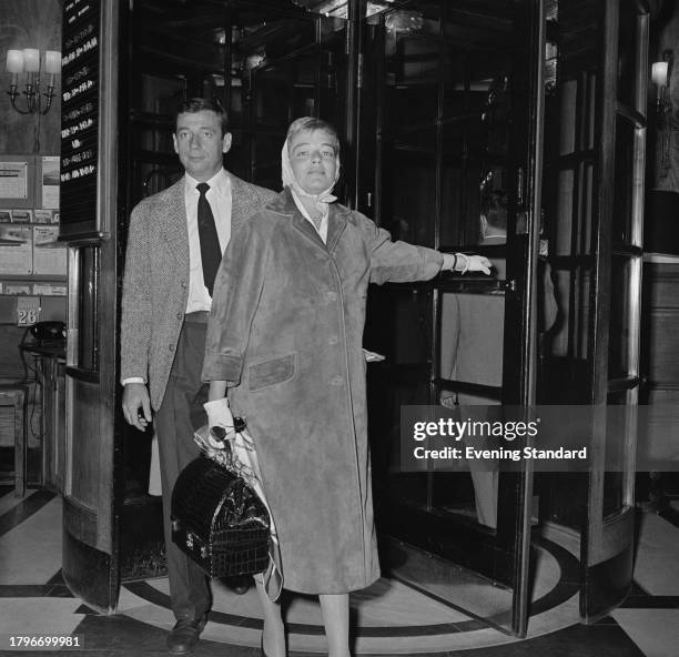 French actor Yves Montand with his wife, actress Simone Signoret entering the Savoy Hotel, London, August 29th 1957.