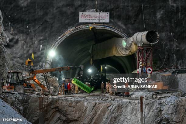 Crane carries a part of drilling machine as rescue operation enters its final phase, for workers trapped in the Silkyara under construction road...