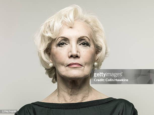 older confident woman - ohrring stock-fotos und bilder