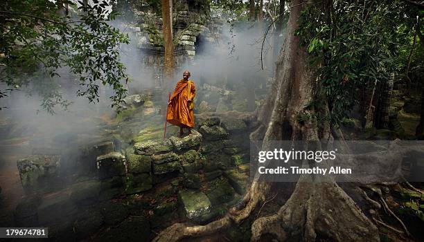 buddhist monk at angkor wat temple complex - angkor wat stock pictures, royalty-free photos & images