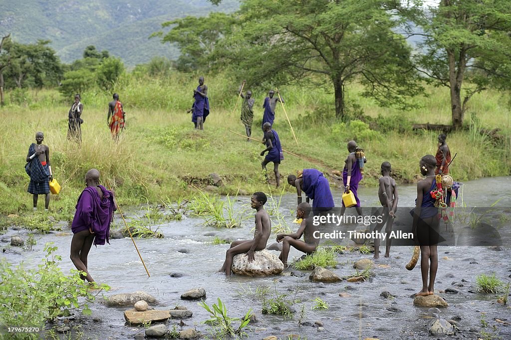 Suri tribe collect water from river, Omo Valley