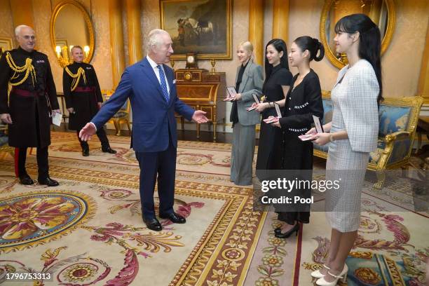 King Charles III presents the members of the K-Pop band Blackpink, Rose , Jisoo Kim, Jennie Kim, and Lisa , with Honorary MBEs (MBE during a special...