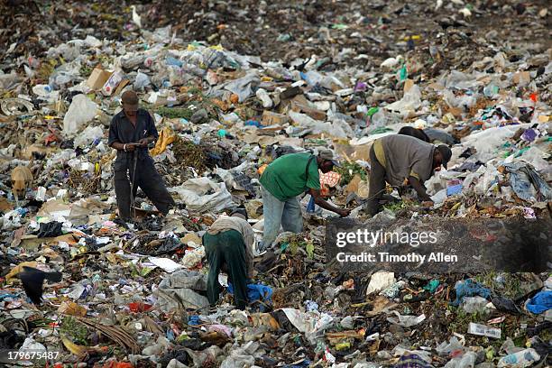 kenyan men scavenge at kibarani dump - mombasa stock pictures, royalty-free photos & images