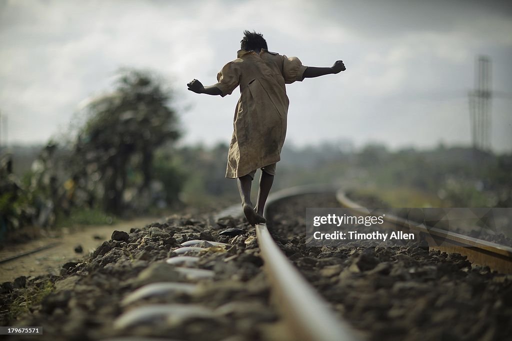 Kenyan girl walking on train tracks