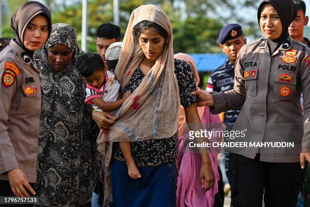 Rohingya refugees board a ferry at a beach in the Sabang island of Aceh province, Indonesia on November 22 as they are relocated by Indonesian...