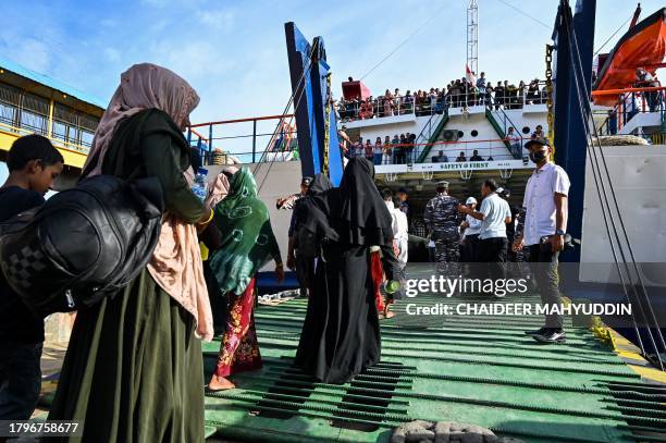 Rohingya refugees board a ferry at a beach in the Sabang island of Aceh province, Indonesia on November 22 as they are relocated by Indonesian...