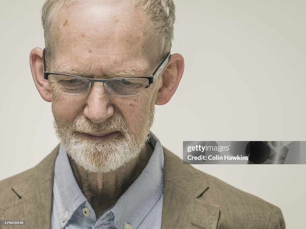 Portrait of elderly man looking down
