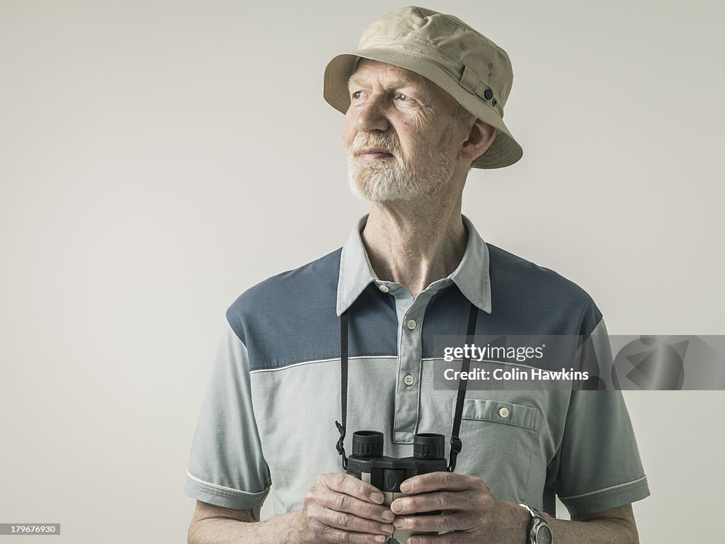 Elderly man with binoculars