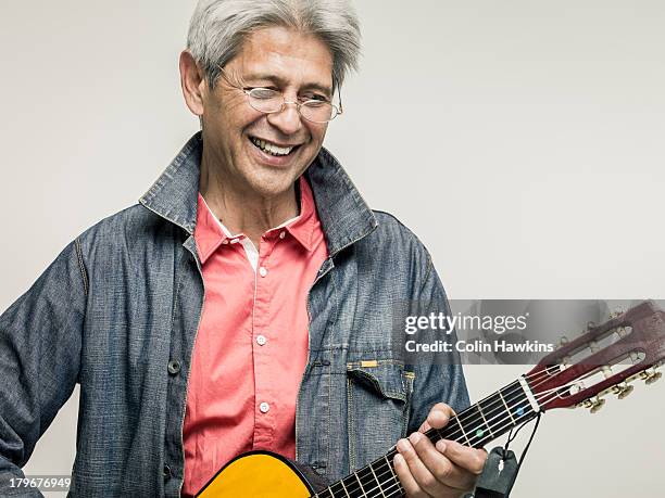 senior male playing guitar - musician male energy stock-fotos und bilder