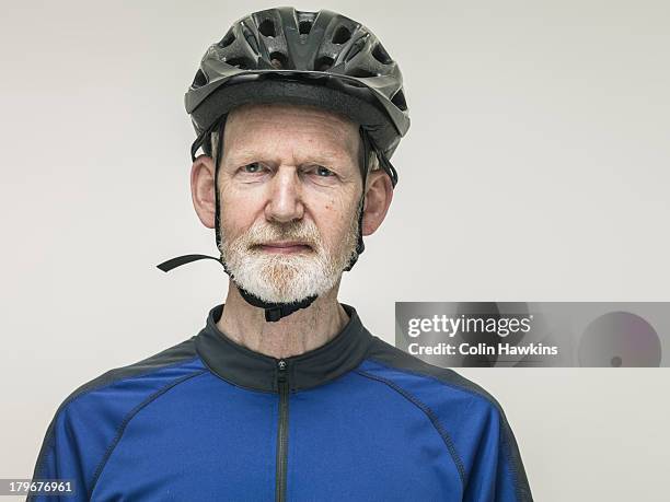 portrait of elderly male cyclist - cycling helmet stock-fotos und bilder
