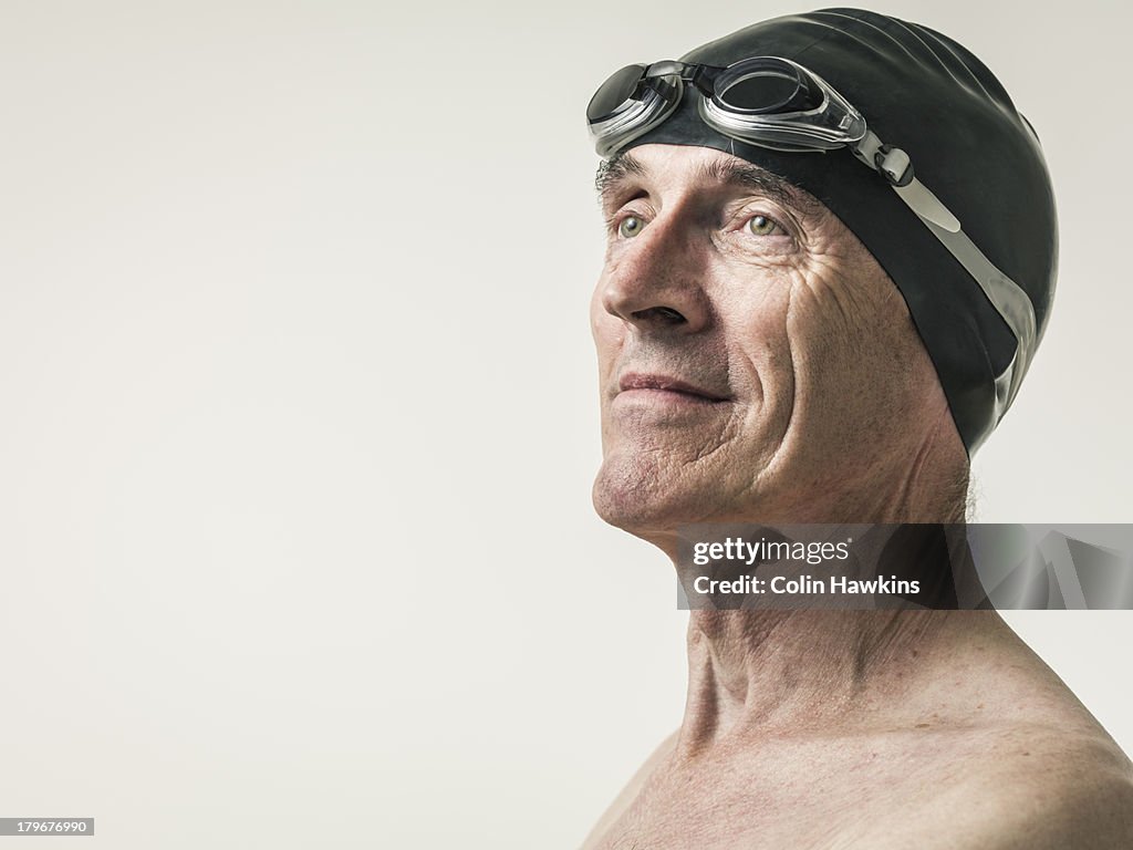 Elderly man in swim hat and goggles