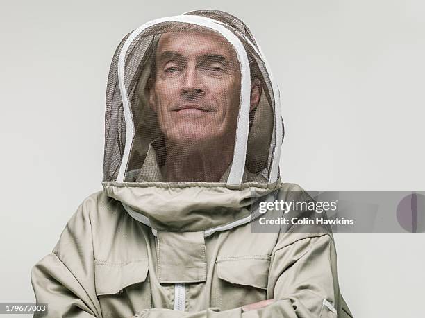 elderly male beekeeper - beekeeper stock-fotos und bilder