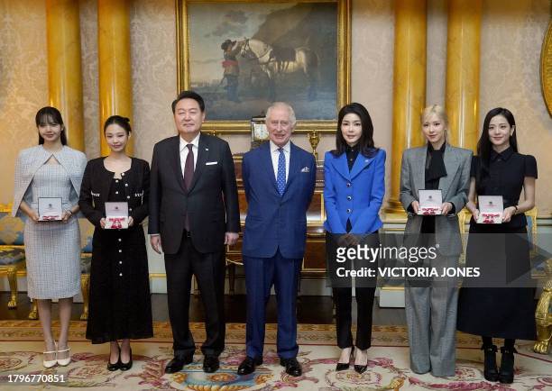 Britain's King Charles III stands with South Korea's President Yoon Suk Yeol , South Korea's First Lady Kim Keon Hee , and K-Pop band Blackpink's...