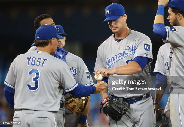 Will Smith of the Kansas City Royals is relieved in the eighth inning as manager Ned Yost makes a pitching change during MLB game action against the...