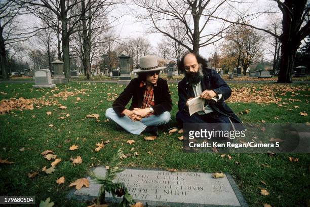 Musician Bob Dylan and poet Allen Ginsberg are photographed at Jack Keuroac's grave during the Rolling Thunder Revue in October 1975 in Lowell,...