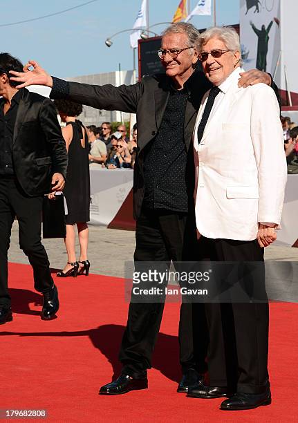 Italian press agent Enrico Lucherini stands next to Film Director Ettore Scola on the red carpet before Scola receivedthe 'Jaeger-LeCoultre Glory To...