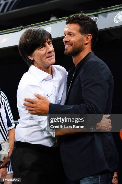 Head coach Joachim Loew hughs former player Michael Ballack during the FIFA 2014 World Cup Qualifying Group C match between Germany and Austria on...