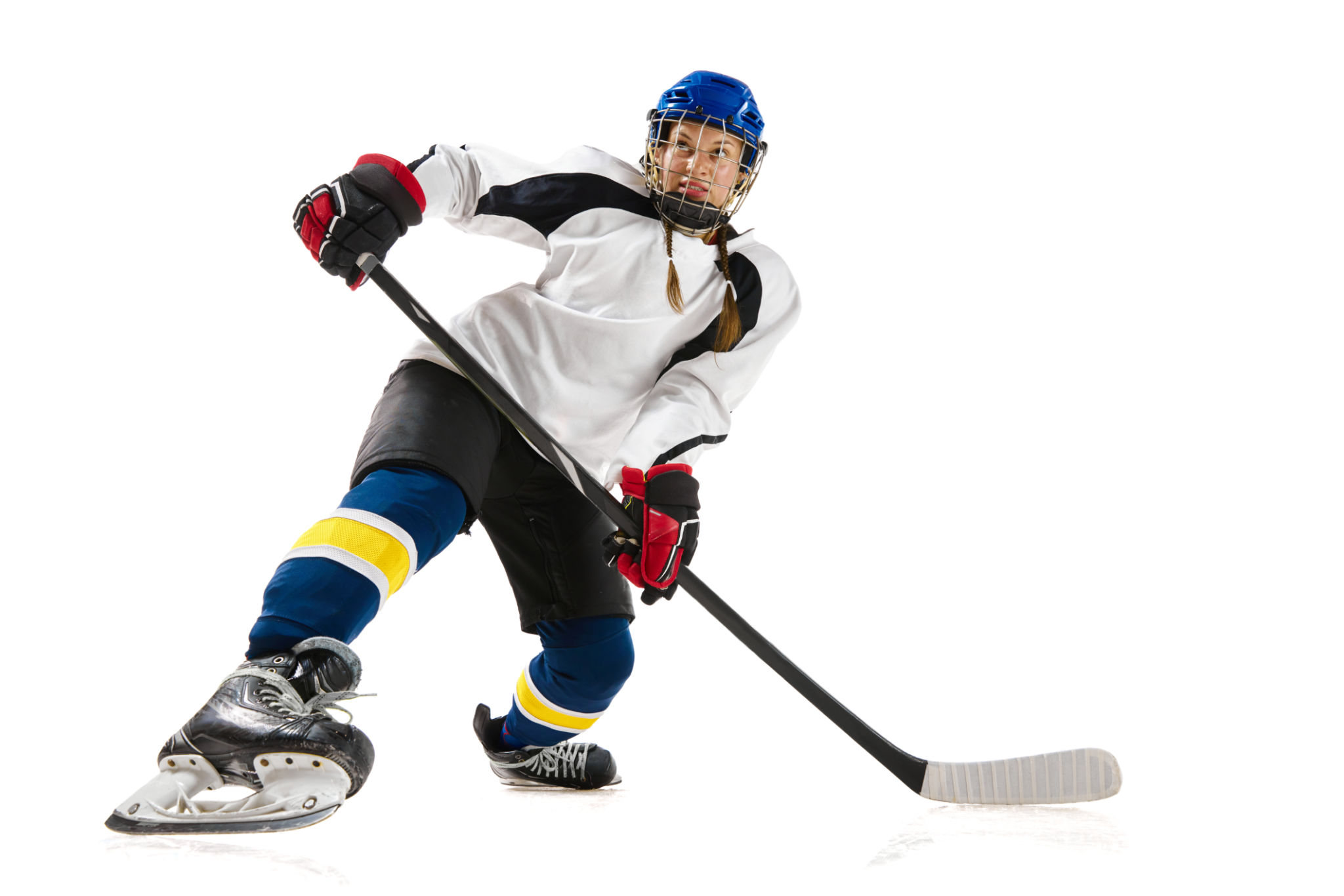 Young girl, hockey playing in helmet, uniform, with stick training, playing isolated over white background Young girl, hockey playing in helmet, uniform, with stick training, playing isolated over white background