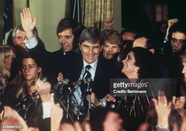 Republican Party politician John Warner waves to supporters, including actress Elizabeth Taylor , after winning the Virginia Senate Election,...