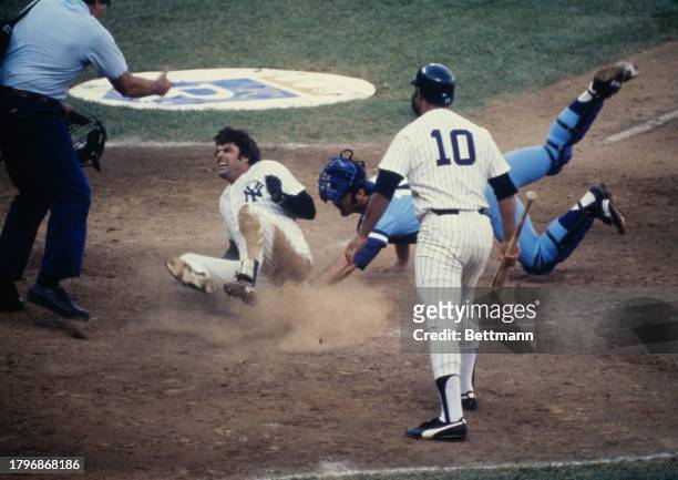 Yankees' Lou Piniella is out at home in the 4th trying to score from third on a fly out. Royals' catcher is Darrell Porter. An argument followed in...