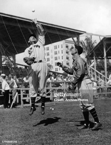 Phil Weintraub , First Baseman and Outfielder for the New York Giants of the National League jumps to catch the baseball as shortstop and third...