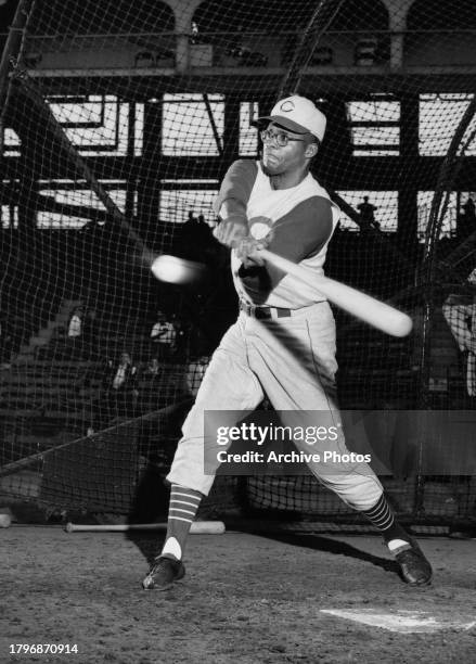 George Crowe , First baseman and Pinch Hitter for the Cincinnati Reds of the National League swings at a pitch inside the batting cage during batting...