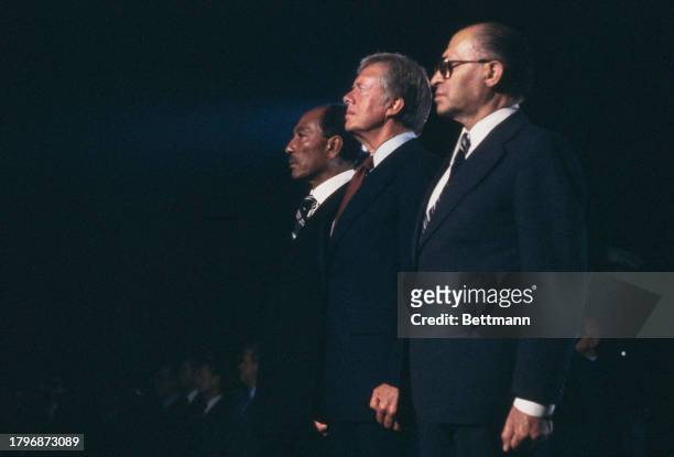 Egyptian President Anwar Al Sadat , US President Jimmy Carter and Israeli Prime Minister Menachem Begin during the playing of the national anthem at...