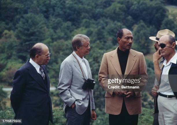 Israeli Prime Minister Menachem Begin , US President Jimmy Carter, Egyptian President Anwar Al Sadat , park ranger Robert Prosperi and Israeli...