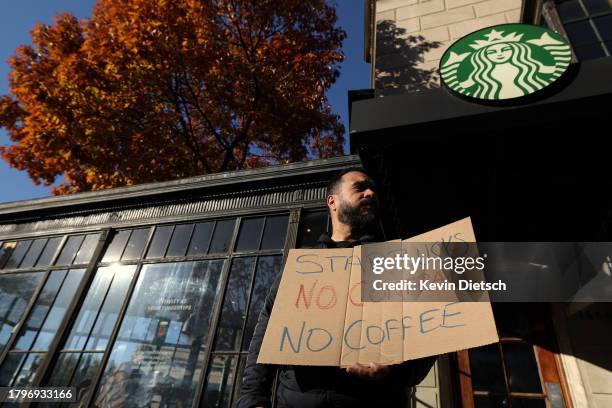 Members and supporters of Starbucks Workers United protest outside of a Starbucks store in Dupont Circle on November 16, 2023 in Washington, DC. The...