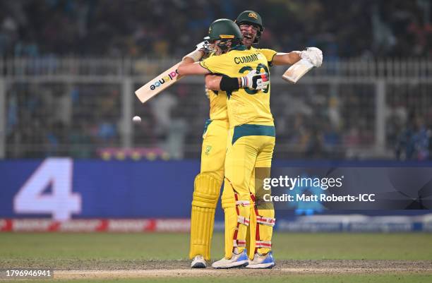 Mitchell Starc and Pat Cummins of Australia celebrate victory following the ICC Men's Cricket World Cup India 2023 Semi Final match between South...