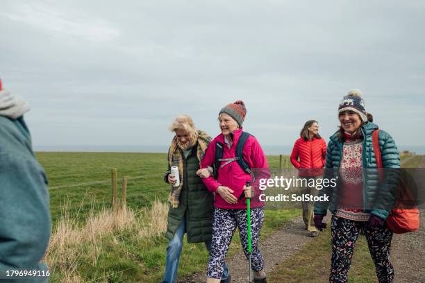 joyful journeys - group of people walking stock pictures, royalty-free photos & images