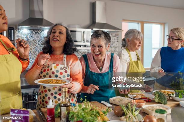 cooking class fun - community effort stock pictures, royalty-free photos & images