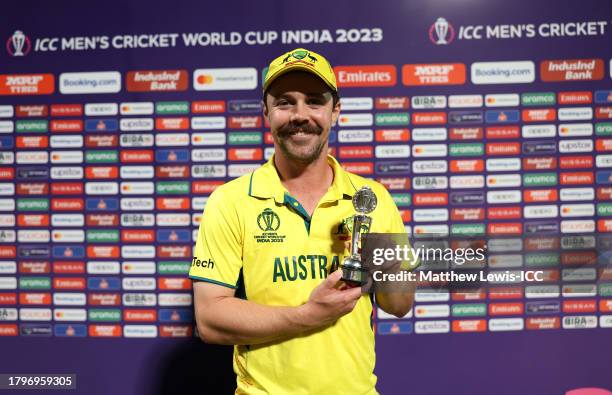 Travis Head of Australia pose for a photo while holding the Player of the Match Trophy following victory in the ICC Men's Cricket World Cup India...