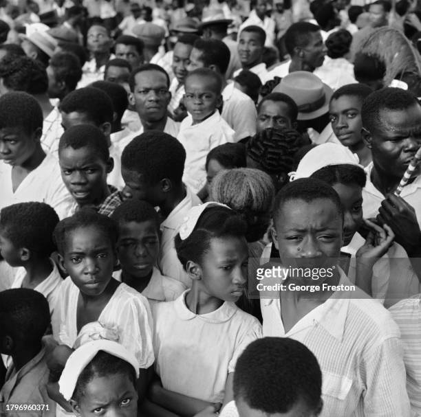 Crowd of people, including boys and girls, in Kingston, Jamaica, August 1962.