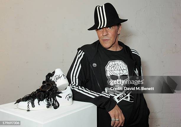 Artist Judy Blame poses with his design at a private view of the Platform Six exhibition with adidas Originals Stan Smith auction in support of...