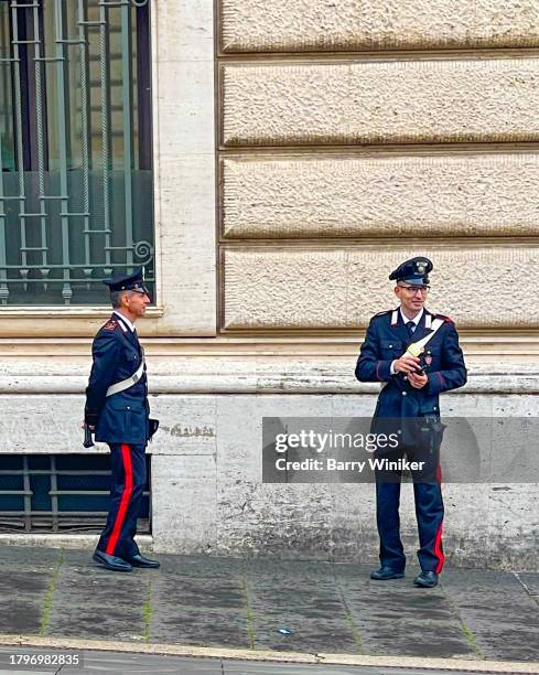 carabinieri standing and smiling on street, rome - carabinieri stock-fotos und bilder