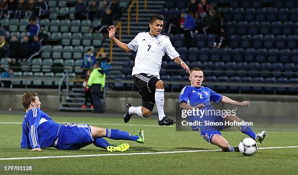 Leonardo Bittencourt of Germany scores his team's third goal against Badrur Hansen and Hordur Askham of Faroe Islands during the UEFA Under21 Euro...