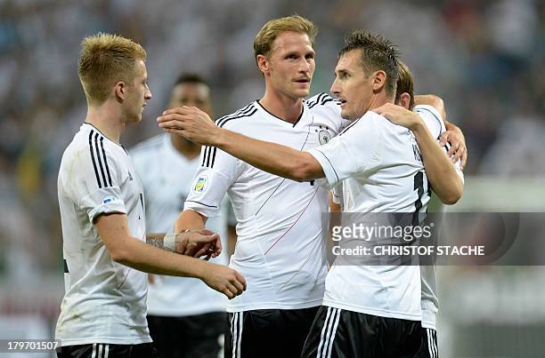 Germany's midfielder Marco Reus, Germany's defender Benedikt Hoewedes, Germany's striker Miroslav Klose and midfielder Toni Kroos celebrate after the...