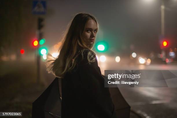 mujer en el fondo de la calle de la ciudad de la noche. - película de suspense fotografías e imágenes de stock